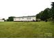 Large backyard featuring a grassy lawn and mature trees at 234 Olin Loop, Olin, NC 28660