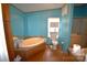 Bathroom featuring a garden tub, wood floors, and ample cabinet space at 234 Olin Loop, Olin, NC 28660