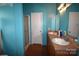 Bathroom with dual sinks, a shower, and a toilet at 234 Olin Loop, Olin, NC 28660