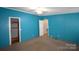 Spacious bedroom with bright blue walls, neutral carpet and a ceiling fan at 234 Olin Loop, Olin, NC 28660