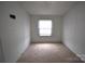 Neutral bedroom with window, carpeted floors and white walls at 234 Olin Loop, Olin, NC 28660
