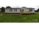 Charming single-Gathering home with a front porch and a well-manicured lawn at 234 Olin Loop, Olin, NC 28660