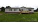 Charming single-story home with a wooden porch and well-manicured lawn at 234 Olin Loop, Olin, NC 28660