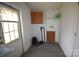 A laundry room featuring a washer/dryer hookup, storage cabinet, and exterior access at 234 Olin Loop, Olin, NC 28660