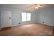 Inviting living room with neutral carpet and walls, complemented by a ceiling fan at 234 Olin Loop, Olin, NC 28660