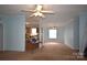 Open-concept living room, adjoins the kitchen, and features neutral walls and carpet at 234 Olin Loop, Olin, NC 28660
