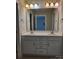 Bathroom featuring a double sink vanity with white cabinets, a large mirror and modern fixtures at 2355 Villa Oaks Ct, Gastonia, NC 28054