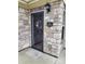 Close-up showcasing the stone facade around the main entrance of the home at 2355 Villa Oaks Ct, Gastonia, NC 28054