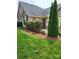 Charming home featuring a stone facade, manicured lawn, and tasteful landscaping for enhanced curb appeal at 2355 Villa Oaks Ct, Gastonia, NC 28054