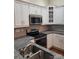 Well-lit kitchen with stainless steel appliances, granite countertops, white cabinets, and a tiled backsplash at 2355 Villa Oaks Ct, Gastonia, NC 28054