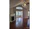Cozy living room showcasing a fireplace, hardwood floors, a ceiling fan and a large bay window at 2355 Villa Oaks Ct, Gastonia, NC 28054