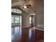 Bright living room with vaulted ceilings, a ceiling fan, and large windows with hardwood flooring at 2355 Villa Oaks Ct, Gastonia, NC 28054