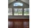 Well-lit living room featuring hardwood floors and large windows offering a view of the outdoors at 2355 Villa Oaks Ct, Gastonia, NC 28054