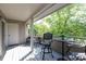 Covered balcony with comfortable seating and tree views providing privacy and a beautiful outdoor space at 2504 Stradbrook Dr # B, Charlotte, NC 28210