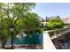 Scenic balcony view featuring mature trees, sparkling pond, and serene surroundings, perfect for unwinding outdoors at 2504 Stradbrook Dr # B, Charlotte, NC 28210