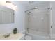 Well-lit bathroom showcasing a tiled shower-tub combo, vanity, and a modern design for comfort at 2504 Stradbrook Dr # B, Charlotte, NC 28210