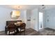 Cozy dining area featuring modern lighting, warm wood accents, and convenient access to laundry and entry at 2504 Stradbrook Dr # B, Charlotte, NC 28210