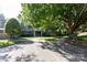 View of the condo building exterior with well-maintained landscaping and parking at 2504 Stradbrook Dr # B, Charlotte, NC 28210