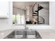 A view from the kitchen to the living room shows a fireplace and spiral staircase at 2504 Stradbrook Dr # B, Charlotte, NC 28210