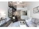 Open-concept living room with a spiral staircase, modern furnishings, and a view of the dining area at 2504 Stradbrook Dr # B, Charlotte, NC 28210