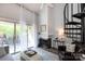 Bright living room featuring a fireplace, spiral staircase, and sliding glass doors to the deck at 2504 Stradbrook Dr # B, Charlotte, NC 28210