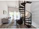 Bright living room with a spiral staircase, comfortable seating, and access to a private outdoor space at 2504 Stradbrook Dr # B, Charlotte, NC 28210