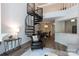 Sunlit living room with modern spiral staircase, elegant decor, and open layout for comfortable living at 2504 Stradbrook Dr # B, Charlotte, NC 28210