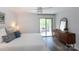 Bright main bedroom features a ceiling fan, a sliding glass door and neutral decor at 2504 Stradbrook Dr # B, Charlotte, NC 28210