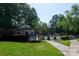 Exterior view of the fenced in pool area with lush landscaping and seating at 2504 Stradbrook Dr # B, Charlotte, NC 28210
