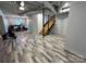 Open basement with stylish flooring, staircase, and ample space for various activities at 2701 N Sharon Amity Rd, Charlotte, NC 28205