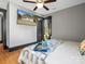 Relaxing bedroom with a mounted television, hardwood floors and natural lighting at 2701 N Sharon Amity Rd, Charlotte, NC 28205