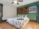 Cozy bedroom featuring a unique wooden headboard, bright green wall, and natural lighting at 2701 N Sharon Amity Rd, Charlotte, NC 28205