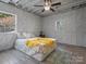 Cozy bedroom with a ceiling fan, a queen bed, and a yellow blanket at 2701 N Sharon Amity Rd, Charlotte, NC 28205