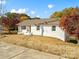 Charming white brick home with a well-maintained lawn and mature trees at 2701 N Sharon Amity Rd, Charlotte, NC 28205