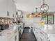 Bright kitchen featuring marble countertops, stainless steel appliances, and modern black and white backsplash at 2701 N Sharon Amity Rd, Charlotte, NC 28205