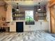 Charming kitchen features unique backsplash, wooden shelves, and stainless steel appliances at 2701 N Sharon Amity Rd, Charlotte, NC 28205