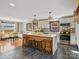 Open kitchen with a marble island, seating, stainless steel appliances and modern light fixtures at 2701 N Sharon Amity Rd, Charlotte, NC 28205