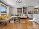 Bright open-concept living room and kitchen featuring hardwood floors and modern light fixture at 2701 N Sharon Amity Rd, Charlotte, NC 28205