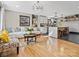 Open-concept living room and kitchen with hardwood floors, modern lighting, and eclectic decor at 2701 N Sharon Amity Rd, Charlotte, NC 28205