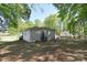 Wide backyard view with a detached building, swingset, and mature shade trees at 315 N Kimmons St, Landis, NC 28088