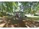 Backyard featuring play equipment and landscaping under the shade of mature trees at 315 N Kimmons St, Landis, NC 28088