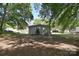 Backyard with a detached garage or shed, mature trees, and lawn area at 315 N Kimmons St, Landis, NC 28088