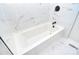 Clean bathroom showcasing a tub with sleek fixtures and white marble-look tiles at 315 N Kimmons St, Landis, NC 28088