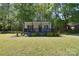 Charming single-story home with a inviting front porch, manicured lawn, and mature trees providing ample shade at 315 N Kimmons St, Landis, NC 28088