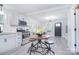 Open concept kitchen showing stainless appliances, modern lighting, and access to the front door at 315 N Kimmons St, Landis, NC 28088