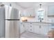Bright kitchen features stainless steel appliances, white cabinets, and modern faucet at 315 N Kimmons St, Landis, NC 28088
