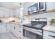 Well-lit kitchen featuring granite counters, stainless appliances, and undermount cabinet lighting at 315 N Kimmons St, Landis, NC 28088