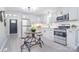 Bright kitchen featuring stainless steel appliances, white cabinets, and a modern breakfast table at 315 N Kimmons St, Landis, NC 28088