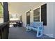 Charming covered porch boasts a stylish rocking bench, and a cozy seating area at 315 N Kimmons St, Landis, NC 28088