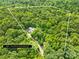 An aerial view of the house and property lines showing a 5.33 acre lot covered by lush greenery at 32060A Flint Ridge Rd, Albemarle, NC 28001